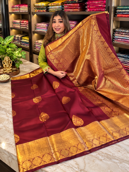 Festive Maroon Soft Banarasi Silk Saree with Elegant Gold Zari Paisley Motifs