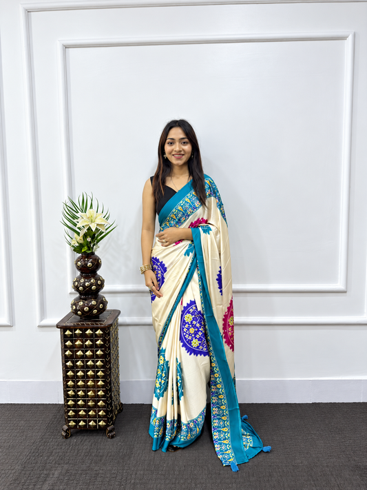 Celeb Inspired Cream Satin Silk Saree with Rama Teal Mandala Prints & Heavy Mirror Embellished Border