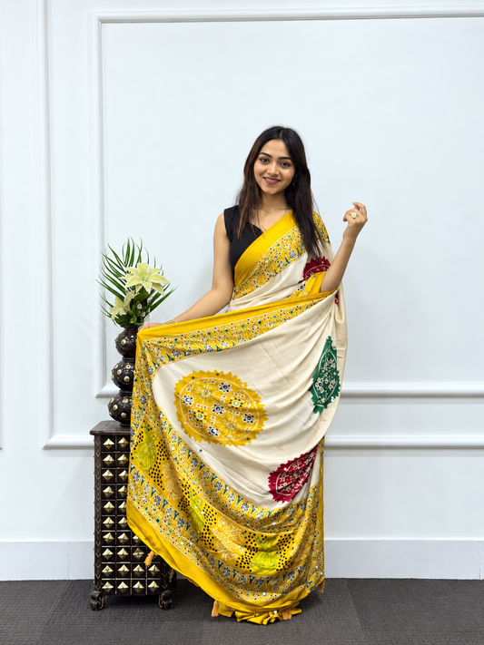 The Haldi-Festive Cream Japan Satin Saree with Mustard Patola Borders & Mirror Work