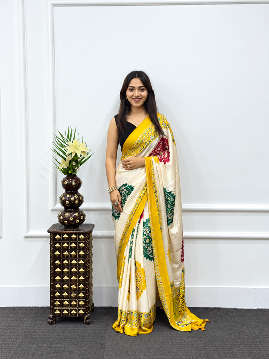 The Haldi-Festive Cream Japan Satin Saree with Mustard Patola Borders & Mirror Work
